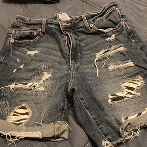 Styled and torn, pre-torn jeans with material behind them